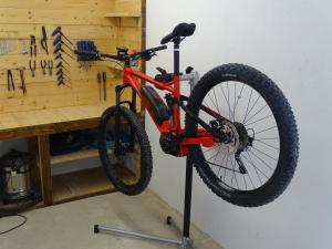 a bike hanging on a stand in a garage at Trattoria della Posta in Peveragno