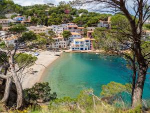 a view of a beach with blue water and houses at Alta House Begur in Begur