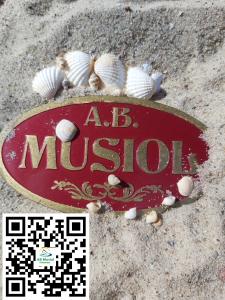 a sign in the sand with shells around it at AB Musiol in Świnoujście
