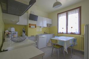 a small kitchen with a table and a table and chairs at COSY HOUSE garden free parking in Bayeux