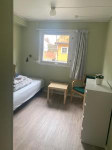 a small bedroom with a bed and a window at Fosseland Gjestegård in Feda +28 photos