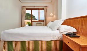 Postel nebo postele na pokoji v ubytování Hotel Juan de la Cosa