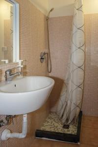 a bathroom with a sink and a shower at Casa Vacanze Marconi in Caltagirone