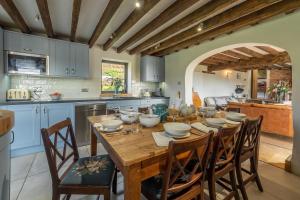 a kitchen and dining room with a wooden table and chairs at Five Acres in Thirsk