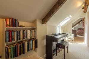 an attic office with a desk and a book shelf with books at Five Acres in Thirsk