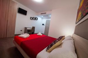 a bedroom with a bed with a red blanket at Perla del sud in Sava
