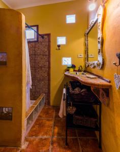 un bagno giallo con lavandino e doccia di Casa Conchilla, La Casita a Valle Gran Rey