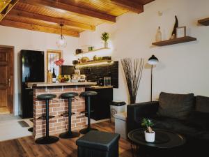 a living room with a couch and a fireplace at Kedvesem Noszvaj in Noszvaj