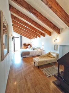 a bedroom with a bed and a couch in a room at Hotel La Casa del Río in Villanova