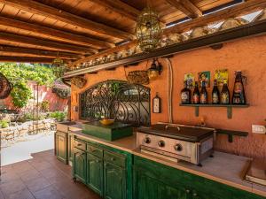 an outdoor kitchen with green cabinets and a stove at Guest House Villa Verde - Short Term Room Rentals in Torre delle Stelle