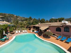 a large swimming pool in front of a house at Guest House Villa Verde - Short Term Room Rentals in Torre delle Stelle