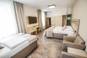 Кровать или кровати в номере Hotel Mariel Znojmo