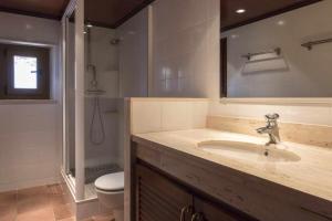 a bathroom with a sink and a toilet and a mirror at Luxury Rocamar - Primera línea de mar-Terraza in Tossa de Mar +40 photos