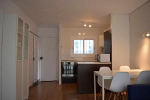 a small kitchen with a table and chairs in a room at Cala LLevado Tossa de M. A/C Parking Piscina in Tossa de Mar