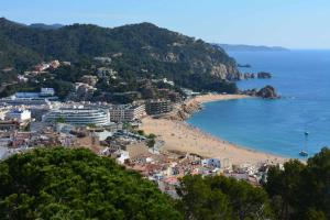 a view of a beach and the ocean at Cala LLevado Tossa de M. A/C Parking Piscina in Tossa de Mar