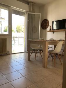 a dining room with a wooden table and chairs at Ca' Adriana in Lido di Jesolo