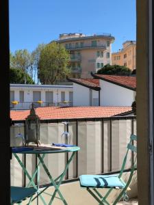 a chair and a table on a balcony at Ca' Adriana in Lido di Jesolo