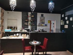 a restaurant with a counter with chairs and a table at Il Mirto E La Rosa in Arenella
