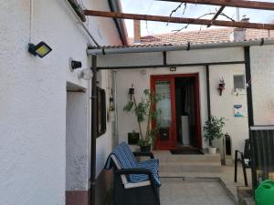a pair of blue chairs sitting outside of a house at Róza vendégszoba in Keszthely