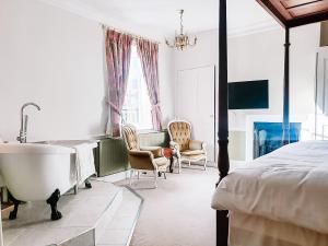 a bedroom with a bed and a bath tub next to at The Quay in Faversham