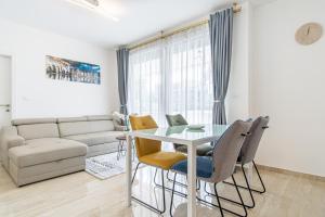 a living room with a glass table and chairs at Ledeno more Luxury Apartments in Split