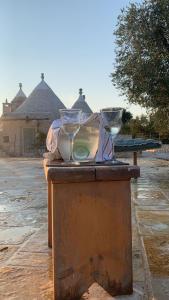 a table with two glasses on top of it at Trulli da Lalli in Ostuni
