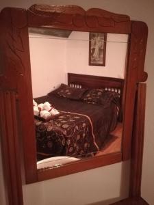 a bedroom with a bed in a mirror at Cueva El Murallon in Benamaurel