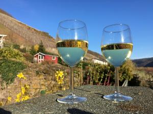 two glasses of white wine sitting on a table at Pension Rehschopp in Ediger-Eller
