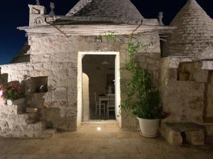 an entrance to a stone house at night at Trulli da Lalli in Ostuni