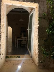 an open door to a dining room with a table at Trulli da Lalli in Ostuni