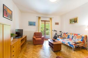 a living room with a couch and a tv at Apartments Sveta Marina in Labin