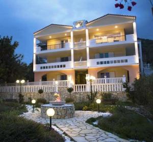 a large white building with lights in front of it at Villa Dolphins in Poros