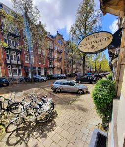 een rij fietsen geparkeerd buiten een hotel mitigationershipershipstrationstratie bij Hotel Washington in Amsterdam