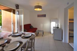 a kitchen and living room with a table and chairs at Résidence U Nebbiu in Olmeta-di-Tuda +17 photos