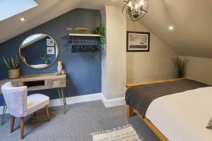 a bedroom with a bed and a mirror and a desk at Host & Stay - The Green Door in Richmond