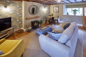 a living room with a couch and a television at Host & Stay - The Green Door in Richmond