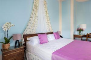 Postel nebo postele na pokoji v ubytování Villa Pitiana