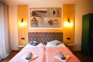 a room with two beds with towels on them at NIECH TO SZLAK B&B in Wisła