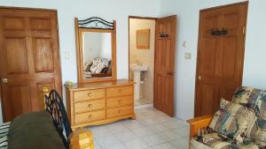 a living room with a dresser and a mirror at AIRBAB Moon Gate East in Mount Pleasant