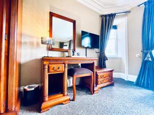 a living room with a wooden floor and a large mirror at Invergarry Hotel in Invergarry