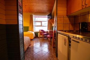 a kitchen with a table and chairs in a room at Tysfjord Hotel in Storjord I Tysfjord