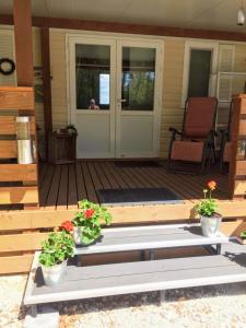 a wooden porch with two potted plants on it at Istria camp - Istria holiday for 2 in Kringa