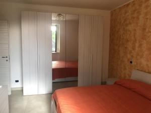a bedroom with a bed and a closet and a window at Villa Giantonia in Minturno