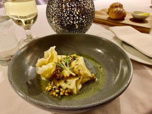 a plate of food with dumplings and beans on a table at Valhalla Perisher in Perisher Valley
