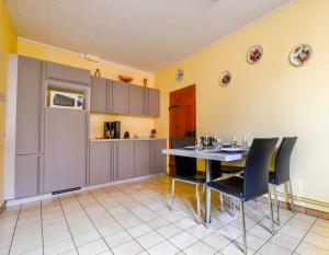 a kitchen and dining room with a table and chairs at Gite de la dime in Ribeauvillé