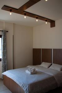 a bedroom with a bed with two towels on it at Lakis Court in Larnaca