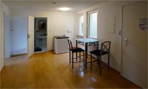 a kitchen with a table and chairs in a room at Zimmerfrei-Wuerzburg Stadtmitte in Würzburg