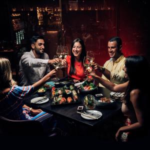 a group of people sitting around a table drinking wine at The Embassy Valletta Hotel in Valletta