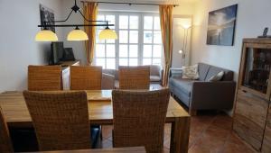 een woonkamer met een houten tafel en stoelen bij Ewertsen in Wyk auf Föhr