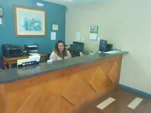 a woman sitting at a counter in a office at Sea Dunes Oceanfront in Myrtle Beach